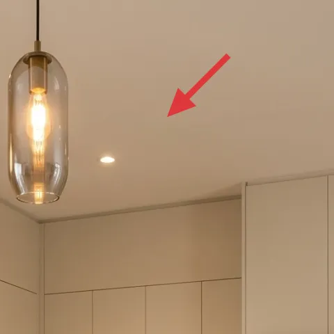 cluster of glass pendant lights with exposed warm bulbs