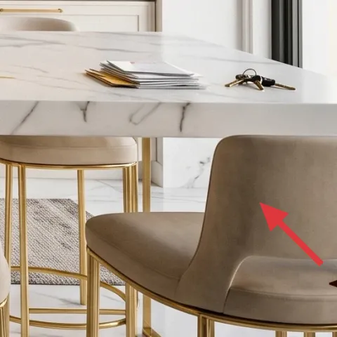 Upholstered beige dining chair with gold legs