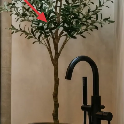Potted leafy plant on the floor by the vanity