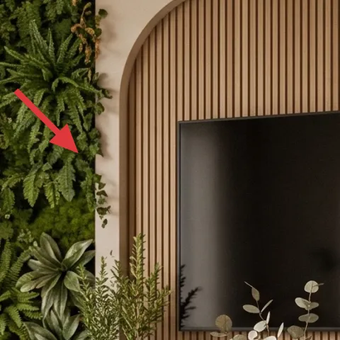 multiple tall potted plants in front of the plant wall panel