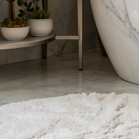 candle set on floor near tub